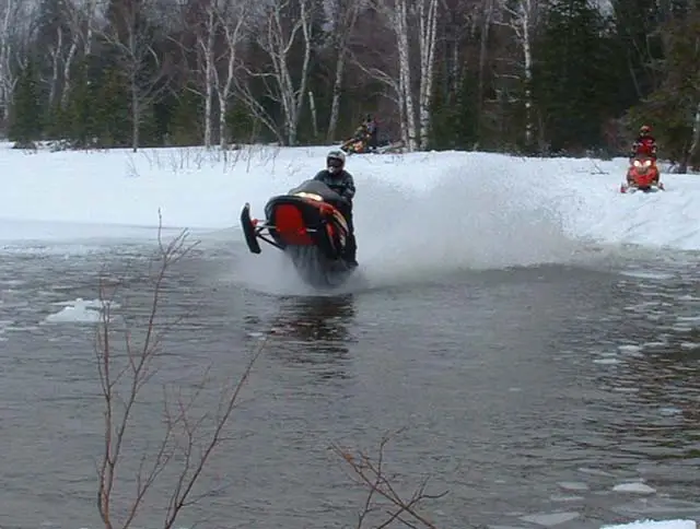 Snowmobiles Skipping Water 111